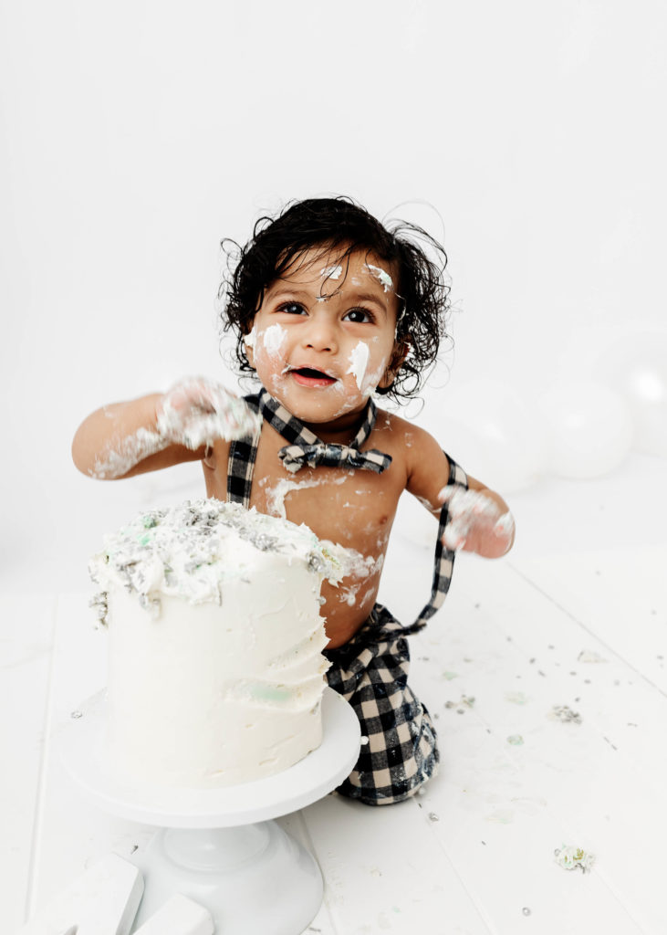 Baby Smiling with a Cake at a Cake smash photoshoot by Lauren Vanier Photography