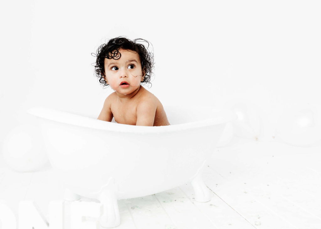 Baby in a bath at the end of a Cake Smash Photoshoot by Lauren Vanier Photography in Hobart Tasmania